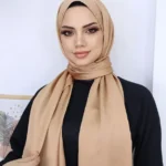 Hijab i metallisk satin guld med elegant glans och mjukt fall Lyxig guld-hijab i satin för Ramadan och fest Stilren hijab med flexibel passform och sofistikerad finish